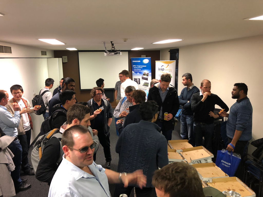 Attendees enjoying pizza and networking at the October meetup